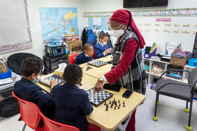 Sister Kathryn Muhammad working with Kindergarten to 3rd graders with their chess skills at the University of Islam No. 20 a private school on Haddon Avenue in Camden, NJ. Photograph taken at school on Monday, April 25, 2022.
