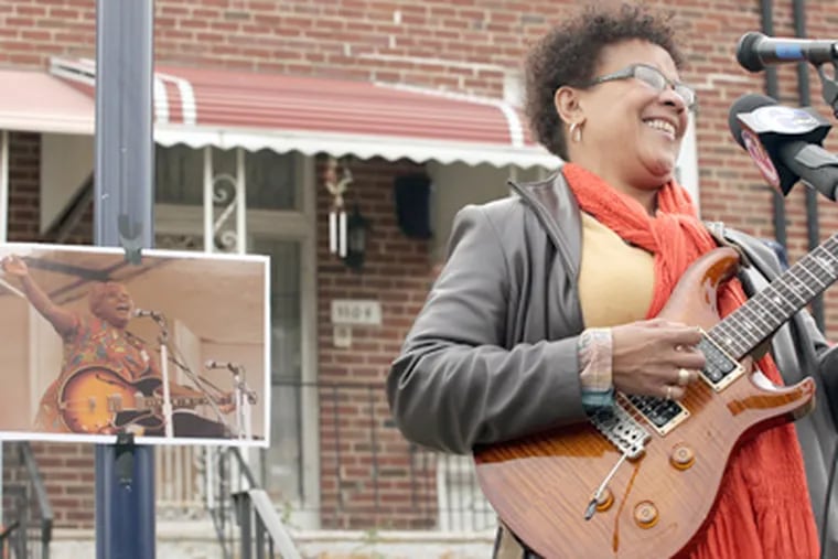 Jazz musician Monnette Sudler plays at the unveiling of the historical marker at the North Philadelphia home of Sister Rosetta Tharpe, shown in the small photo. (Caitlin Morris / Staff Photographer)