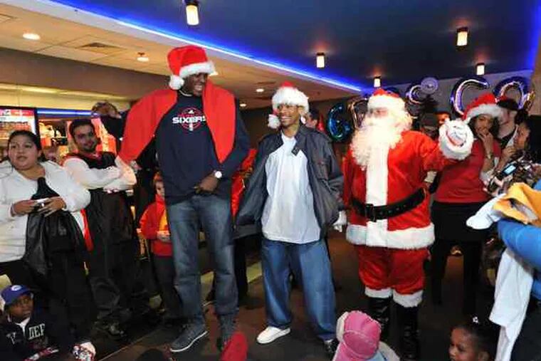 Allen. Allen! ALLENNN! Allen Iverson and 76ers teammate Samuel Dalembert (left) join Santa Claus and 100 kids from Philadelphia's Methodist Home for Children for a preview of &quot;Alvin and the Chipmunks 2.&quot; After the screening Tuesday at the Ritz East in Old City, the men gave every child a present.