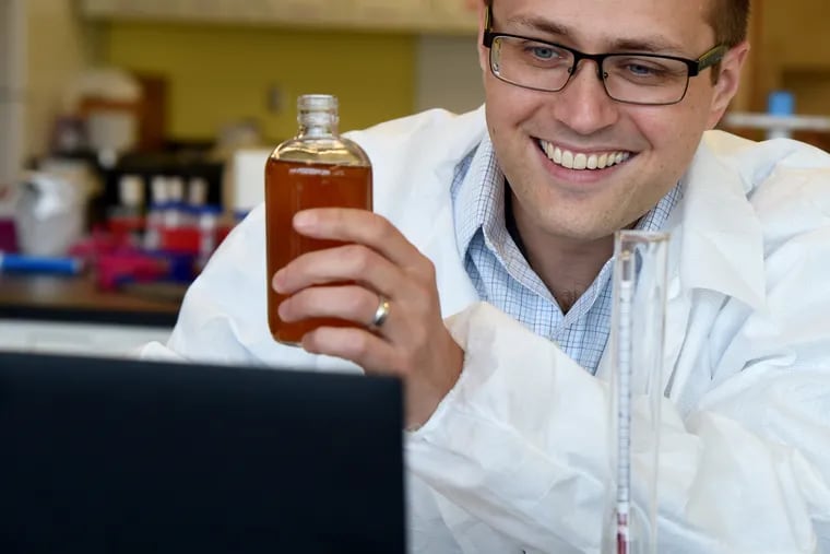 La Salle University professor Brian DeHaven sits in his lab Sept. 16, 2020, as he talks with his microbiology students over Zoom about the beer he - and each of them - brewed at home during the coronavirus pandemic.