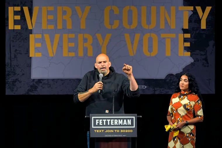 Pennsylvania Lt. Gov. John Fetterman, the Democratic nominee for U.S. Senate seat, campaigns on Aug. 12 in Erie alongside his wife, Gisele Barreto Fetterman.