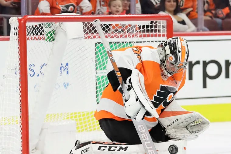 Flyers goaltender Carter Hart, shown making a save in a game last season, stopped all 14 shots he faced in his preseason debut Tuesday against the Islanders at Nassau Coliseum.