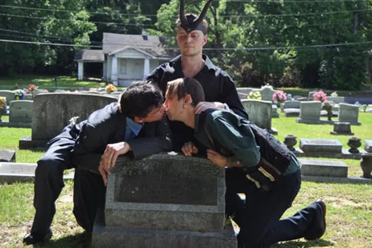 Lucien Greaves, the founder of New York’s Satanic Temple, officiated two “Pink Masses” July 14 over the grave of controversial pastor Fred Phelp’s mother Catherine Idalette Johnson. Two pairs of same-sex couples kissed over Johnson’s gravestone as Greaves wore an “ostentatious” set of horns and mumbled dark incantations. (Provided)