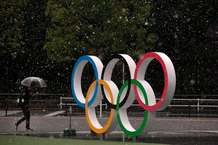 Snow falls on the Olympic rings near the New National Stadium in Tokyo earlier this month.