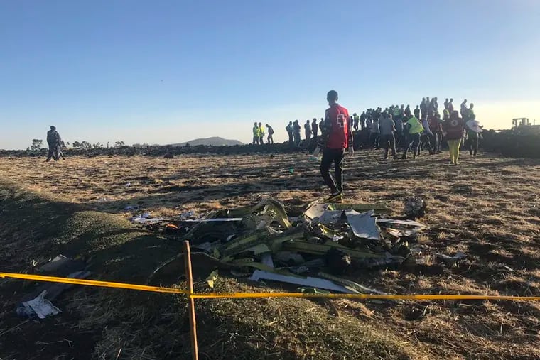 Rescuers search at the scene of an Ethiopian Airlines flight that crashed shortly after takeoff.