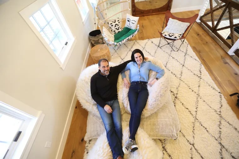 Marc and Beth Hixson relax in the TV lounge, which they added on the second floor landing when they rebuilt a rancher in Devon.