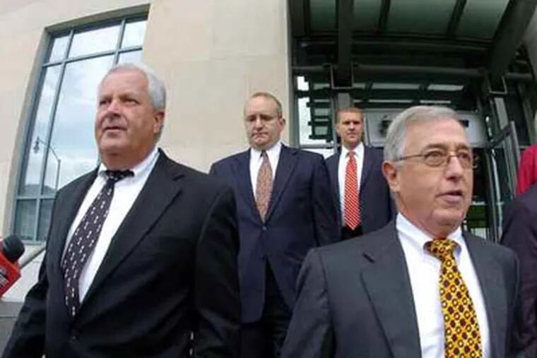 Former Luzerne County Court Judges Michael Conahan, front left, and Mark Ciavarella, front right, leave the U.S. District Courthouse in Scranton, Pa., Sept. 15, 2009, after being arraigned on federal racketeering charges. (AP Photo/The Citizens' Voice, Mark Moran)