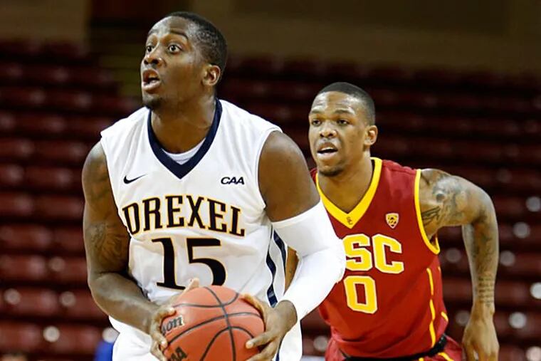 Drexel's Mohamed Bah, left, drives to the basket past Southern California's Darion Clark during the first half of an NCAA college basketball game at the Charleston Classic tournament in Charleston, S.C., Friday, Nov. 21, 2014. (Mic Smith/AP)