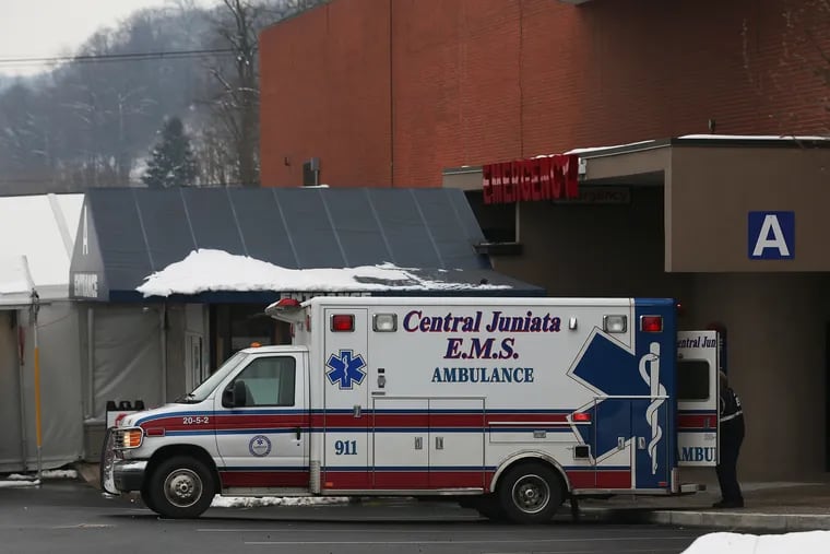 An ambulance is parked outside the emergency entrance to Geisinger Lewistown Hospital in Lewistown, Pa., on Sunday, Dec. 20, 2020. COVID-19 deaths are surging across rural Pennsylvania, including Mifflin County.