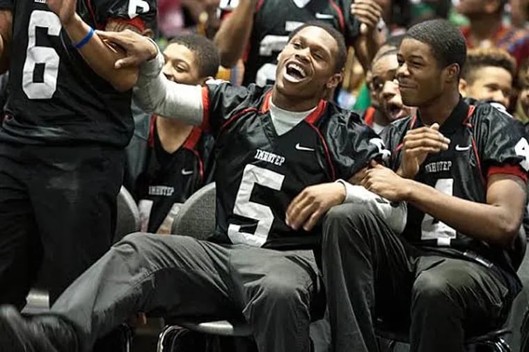 Imhotep Charter's Deandre Scott  (#5) celebrates with teammates during
a pep rally for their state run. ( RON TARVER / Staff Photographer )
December 12, 2013