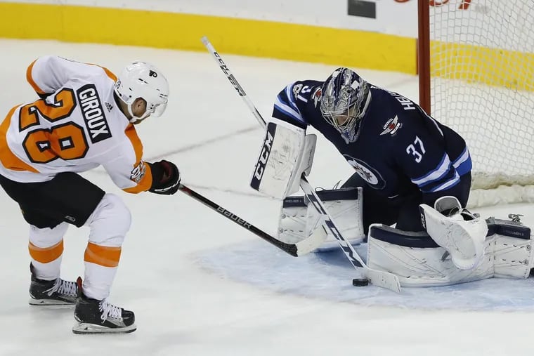 Winnipeg goaltender Connor Hellebuyck stops  Claude Giroux in Thursday’s shootout. If Giroux had scored, the Flyers would have won.