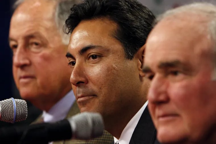 Lame-duck general manager Ruben Amaro Jr. is flanked by Pat Gillick (left) and David Montgomery. (Joseph Kaczmarek/Associated Press)