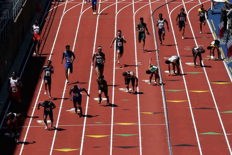 Runners compete in a college men's 4x100 race during the 125th annual Penn Relays at Franklin Field in Philadelphia on Saturday, April 27, 2019.