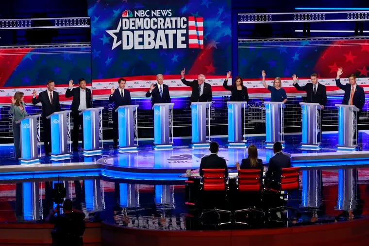 Democratic presidential candidates, author Marianne Williamson, former Colorado Gov. John Hickenlooper, entrepreneur Andrew Yang, South Bend Mayor Pete Buttigieg, former Vice President Joe Biden, Sen. Bernie Sanders, I-Vt., Sen. Kamala Harris, D-Calif., Sen. Kirsten Gillibrand, D-N.Y., Colorado Sen. Michael Bennet, and Rep. Eric Swalwell, D-Calif., raise their hands when asked if they would provide healthcare for undocumented immigrants, during the Democratic primary debate hosted by NBC News at the Adrienne Arsht Center for the Performing Arts, Thursday, June 27, 2019, in Miami. (AP Photo/Wilfredo Lee)