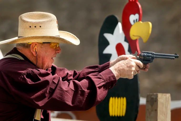 Single Barrel Sam, Larry Humprey of Lake Gaston, N.C., aims his revolver at the silhouette targets at the Matamoras Gun Club in Westfall Township in the Cowboy Action event