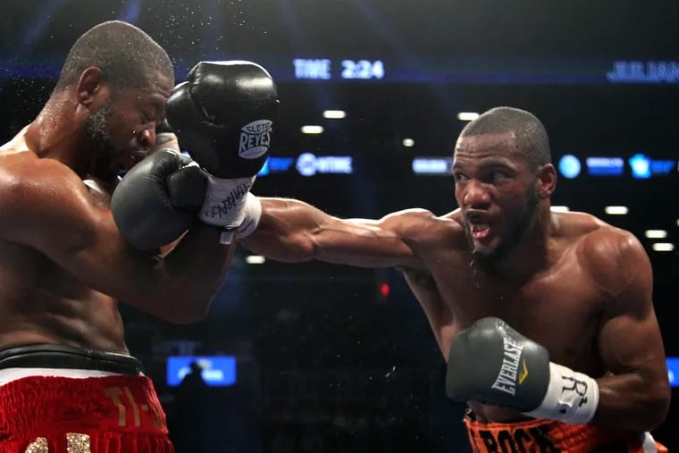 Julian Williams, right, landing a punch on Joachim Alcine during a junior-middleweight match in 2013.
