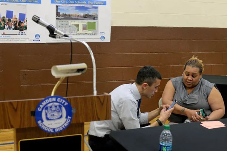 Camden schools chief Paymon Rouhanifard talks with city resident
Zulay Aguilar after his news conference. (TOM GRALISH / Staff Photographer)