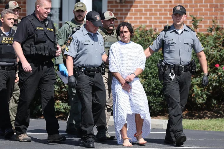 Danilo Cavalcante is escorted from the Pa. State Police barracks in Avondale, Pa. on Wednesday, Sept. 13, 2023.