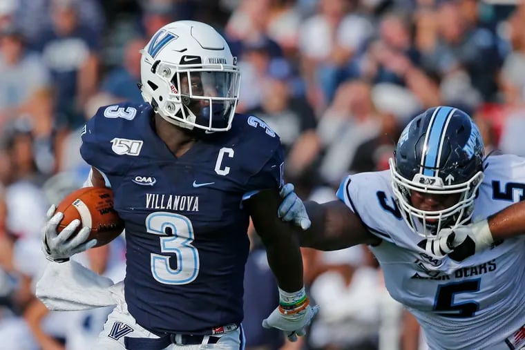 Villanova running back Justin Covington tries to get past Maine defensive lineman Charles Mitchell in the second quarter.