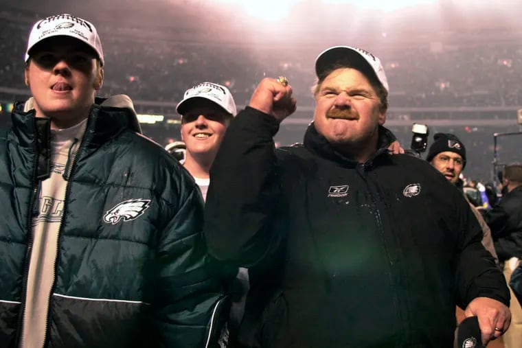 Andy Reid's sons, Garrett (left) and Britt (center), joined him in a celebratory march off the field after a 24-21 victory over the Giants in December 2001.