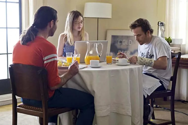 Sitting at a table in &quot;Somewhere&quot; are (from left) Chris Pontius, Elle Fanning, and Stephen Dorff.