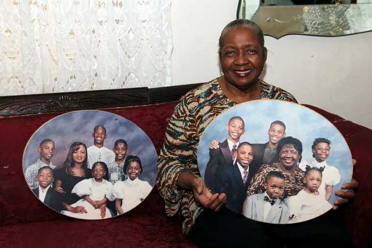 Sharonell Fulton holds a photo of some of the children she has fostered.