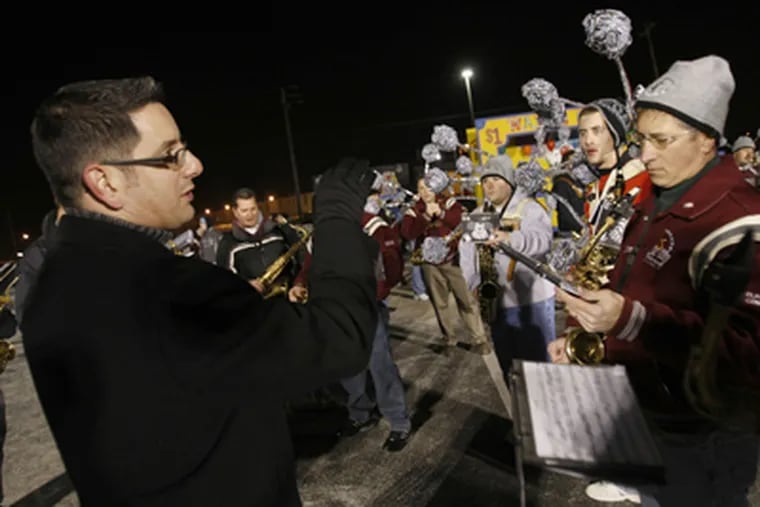 Chris Farr, who teaches saxophone at the University of the Arts, works on an arrangement with the Quaker City String Band during a final rehearsal in a parking lot next to Ikea. (Michael S. Wirtz / Staff Photographer)