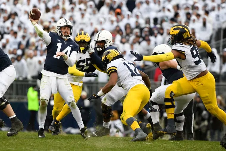 Penn State quarterback Sean Clifford throws while being pressured by Michigan defenders Josh Ross (12) and Mike Morris (90) during a game Nov. 13. Clifford could be in for a big game against a struggling Michigan State pass defense this Saturday.