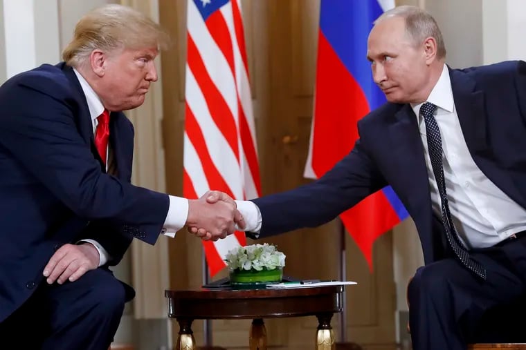 FILE In this file photo taken on Monday, July 16, 2018, U.S. President Donald Trump, left, and Russian President Vladimir Putin shake hands at the beginning of a meeting at the Presidential Palace in Helsinki, Finland.