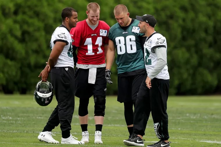 Jordan Hicks (from left), Carson Wentz, Zach Ertz, and Chris Maragos talk during the Eagles' minicamp on Wednesday.