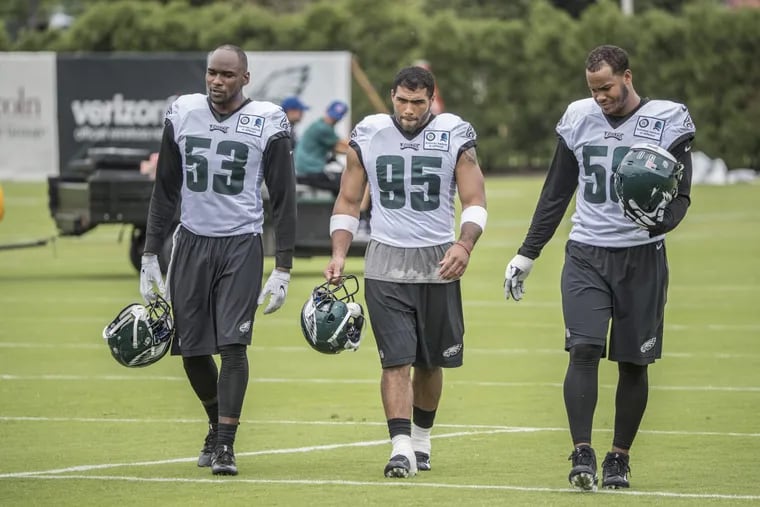 Eagle defensive players Nigel Bradham, #53, left, Mychal Kendricks, #95, and Jordan Hicks, #58, right, walk off the field together after the first full day of practice with the entire team at training camp on Thursday July 27, 2017. Eagles practice with a full squad on Thursday, the first day of training camp for the entire team. 07/27/2017 MICHAEL BRYANT / Staff Photographer