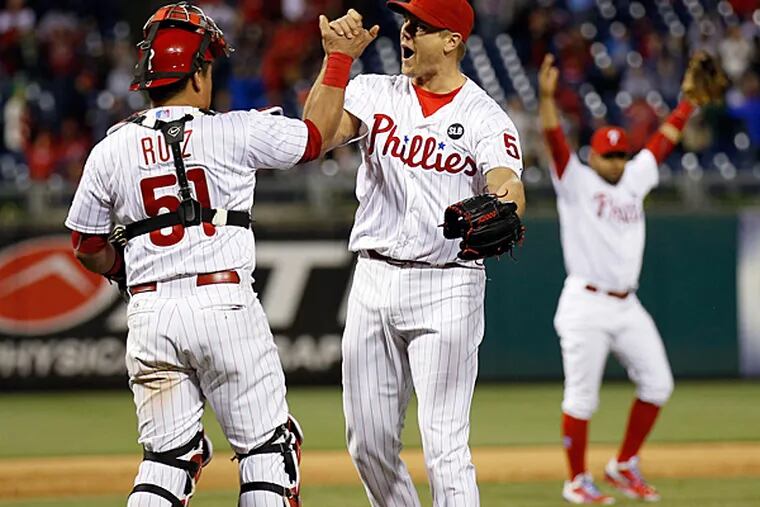 Phillies' pitcher Jonathan Papelbon and catcher Carlos Ruiz celebrate their win over the Pirates.  (Yong Kim/Staff Photographer)