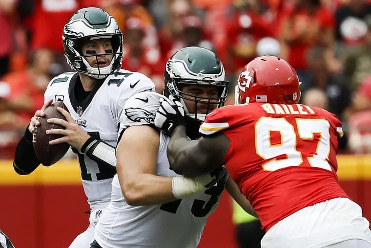 Eagles quarterback Carson Wentz throws the football as offensive guard Isaac Seumalo blocks Kansas City Chiefs defensive end Allen Bailey.