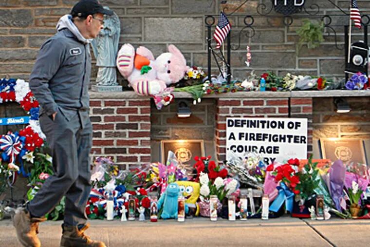 Stopping by a memorial for fallen firefighters in Kensington is neighbor Bruce Meltzer. While their bravery qualifies as heroic, answers sometimes are less clear. ALEJANDRO A. ALVAREZ / Staff Photographer