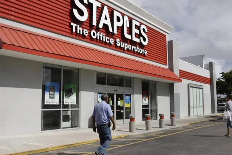 This March 2013 file photo shows a Staples office supply store in Miami. The opening of Postal Service retail centers in dozens of Staples stores around the country is being met with threats of protests and boycotts by the agency's unions. The new outlets are staffed by Staples employees, not postal workers, and labor officials say that move replaces good-paying union jobs with low-wage, nonunion workers. (AP Photo/ Lynne Sladky, File)