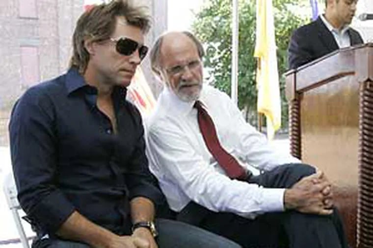 Musician Jon Bon Jovi, left, talks with New Jersey Gov. Jon S. Corzine during a news conference about affordable housing in Newark, N.J. on Tuesday.  Bon Jovi's Philadelphia Soul Charitable Foundation is providing $1 million toward construction of a 51-unit building in Newark that will cater to homeless people with special needs, like AIDS patients. (AP Photo/Mike Derer)
