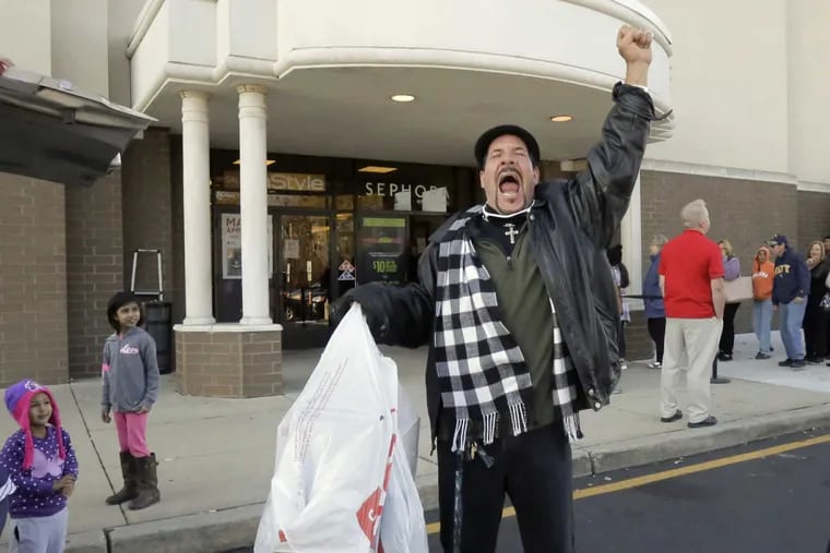 George Barrett of Deptford screams &quot;I&#039;m done, 22 minutes&quot; as he leaves JCPenney after taking advantage of early Black Friday sales on Thanksgiving at JCPenney in Deptford, NJ on November 23, 2017.  The store opened at 2pm.