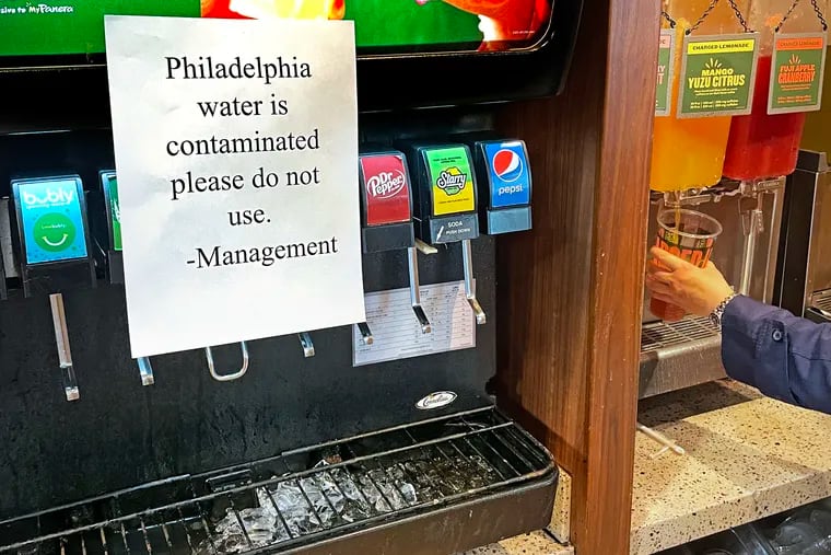 A sign advises diners not to use the water-blended fountain soda in a Center City restaurant on Sunday, March 26, 2023, after Philadelphia officials suggested residents switch to bottled water to avoid ingesting chemicals spilled into a tributary of the Delaware River in Bucks County Friday night.