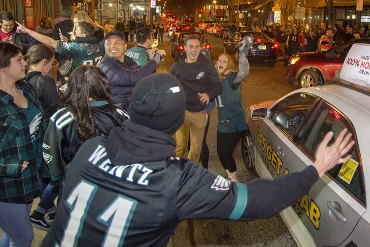 Eagles fans celebrate as they leave the bars along 15th &amp; Locust Streets after the Eagles beat the Vikings for the NFC championship.