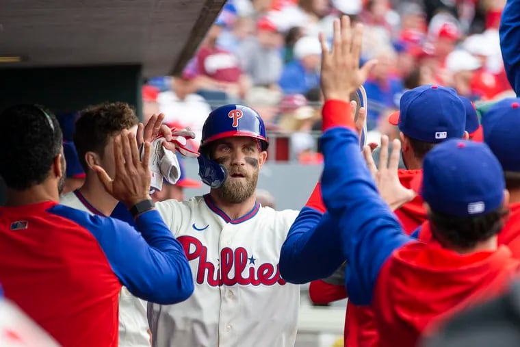 Bryce Harper of the Phillies is congratulated after scoring in the 1st inning against the Brewers on April 23, 2022.  Harper doubled and scored on a double by Nick Castellanos.