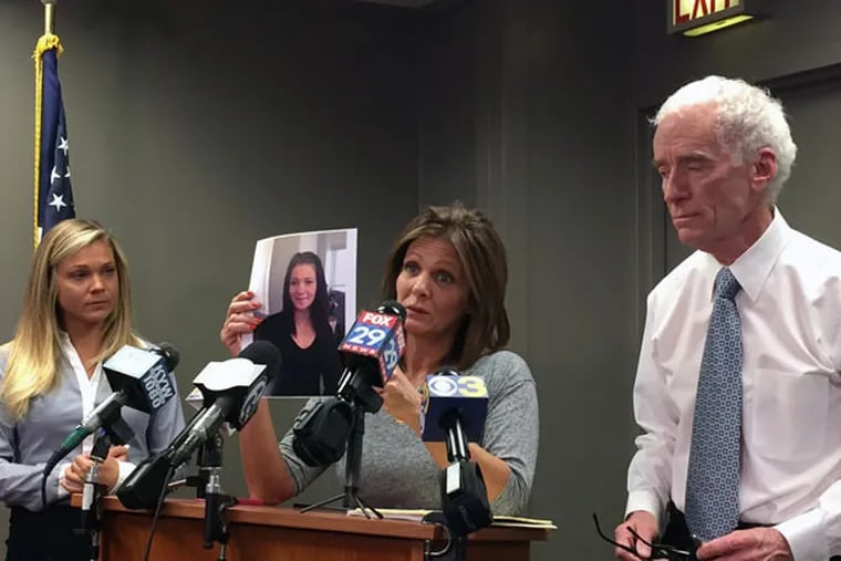 Joanne DeGuio holds up a photo of her missing daughter, Amanda, during a news conference with Upper Darby Police Superintendent Michael Chitwood and Amanda’s sister, Nicole (left). (STEPHANIE FARR / DAILY NEWS STAFF)