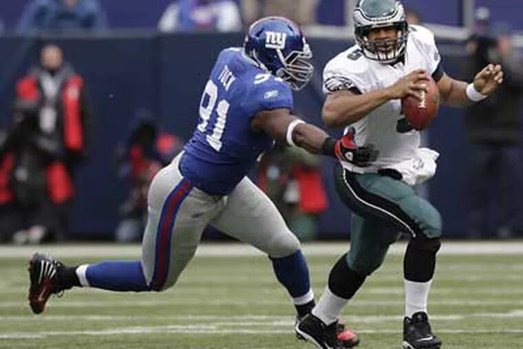 Eagles Donovan Mcnabb scrambles out of the grasp of the Giants' Justin Tuck during the Eagles' win last week.  ( Ron Cortes / Staff Photographer )