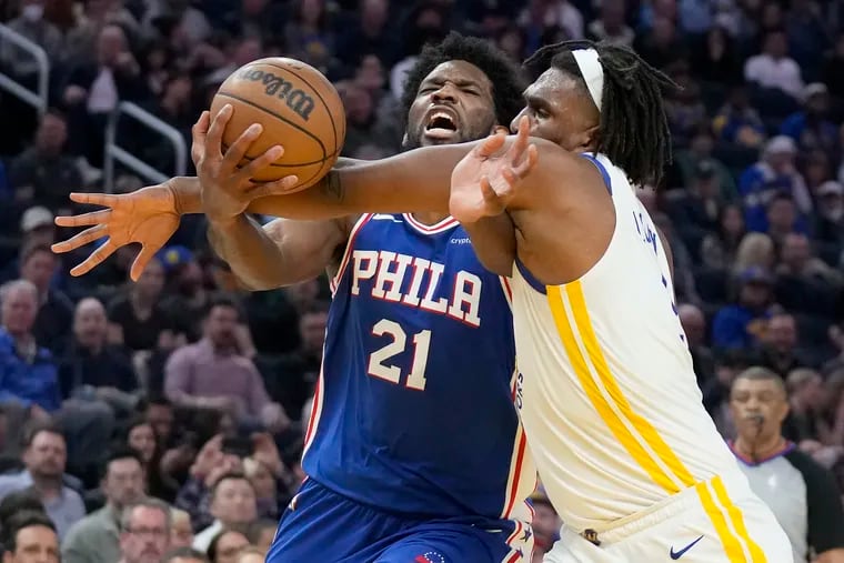 Philadelphia 76ers center Joel Embiid (21) is fouled by Golden State Warriors forward Kevon Looney while driving to the basket during the first half. Embiid had 46 points, nine rebounds, and eight assists in the loss.
