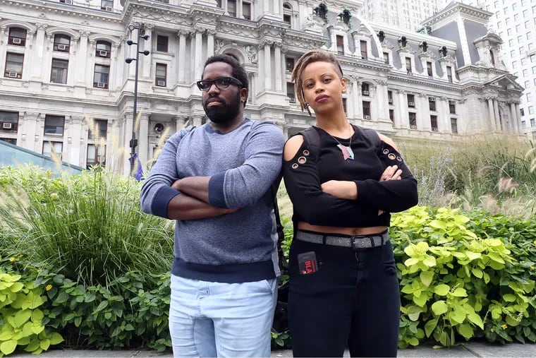 Abdul-Aliy Muhammad and Shani Akilah, members of the Black and Brown Workers' Collective, stand in front of City Hall in 2016. The collective is advocating for 40 percent of city-owned land in each district to be reserved for residents and community members.