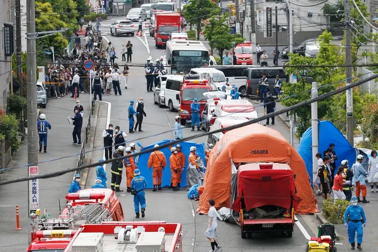 Rescuers work at the scene of an attack in Kawasaki, near Tokyo, Tuesday.