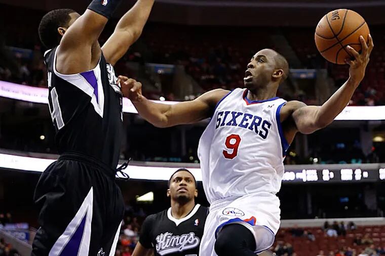 James Anderson, right, goes up to shoot against Sacramento Kings's Jason Thompson during the second half of an NBA basketball game on Wednesday, March 12, 2014, in Philadelphia. (Matt Slocum/AP)