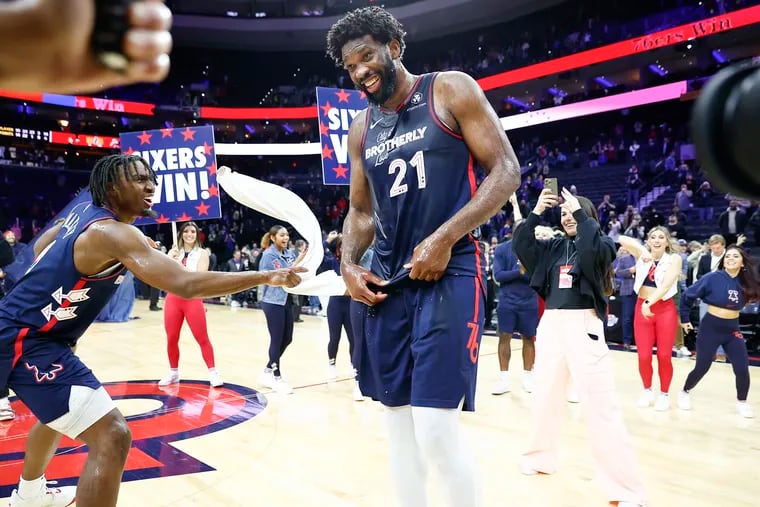 Sixers center Joel Embiid celebrates with guard Tyrese Maxey (left) after scoring 70 points against the San Antonio Spurs on Monday.