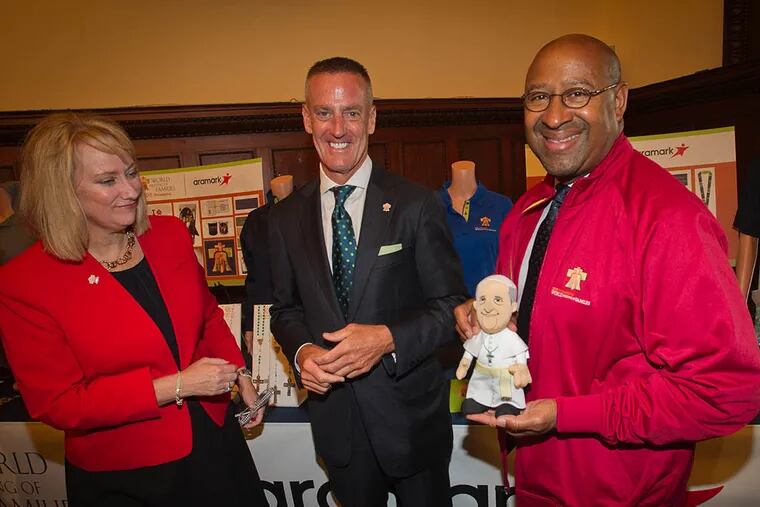 Donna Crilley Farrell (L), Executive Director for World Meeting of Families and Eric J. Foss (C), president and chief executive officer of Aramark, stand with Philadelphia Mayor Michael Nutter who is holding a doll of Pope Francis during the press conference at City Hall to announce details in regard to World Meeting of Families in September, 2015, on June 1, 2015. ( ALEJANDRO A. ALVAREZ / Staff Photographer )
