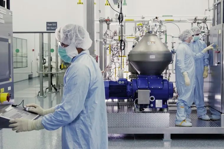 In this image from Regeneron Pharmaceuticals, scientists work with a bioreactor at a company facility in New York state, developing a coronavirus monoclonal antibody drug.
