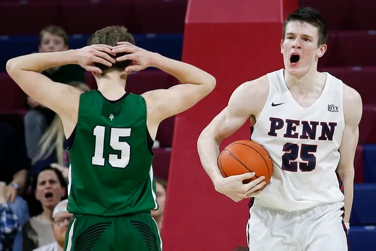 Penn forward AJ Brodeur holds the basketball after grabbing a rebound and getting fouled with under 1 second left on the game clock past Dartmouth guard Brendan Barry during overtime on Friday, February 15, 2019 in Philadelphia.  Penn beat Dartmouth 82-79 in overtime.